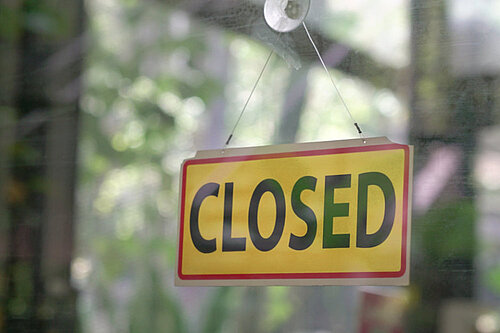 Closed Business A sign reading closed in a window